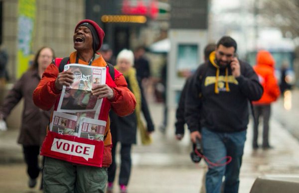 A vendor for the Denver Voice selling newspapers. The vendors sell each paper for a suggested donation of $2.00. Photo courtesy: Denver Voice Twitter page