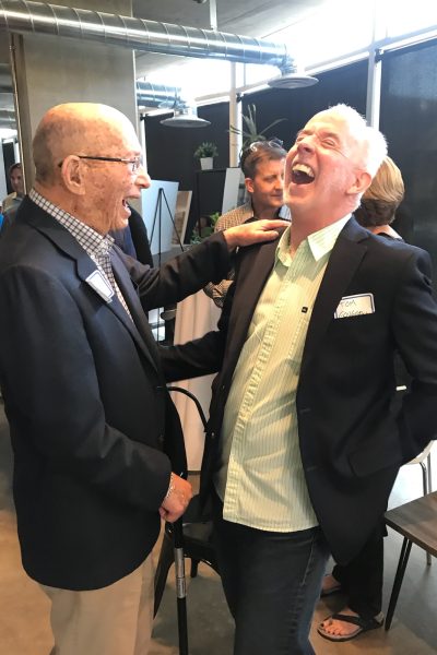 Sam Gary (left) and Tom Gougeon (right) share a laugh during ULC's 15 Year Celebration. Both were integral in creating Urban Land Conservancy.