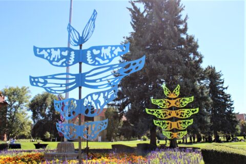 Two of the sculptures from PlatteForum; one with blue wings and one with yellow and green wings